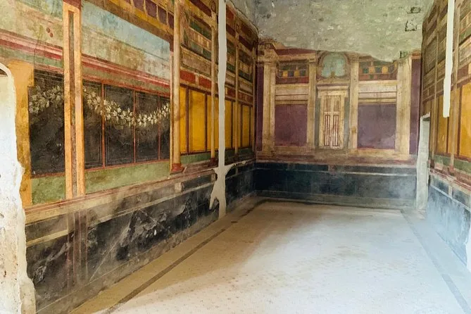 A Roman room with painted walls in red, yellow and black panels
